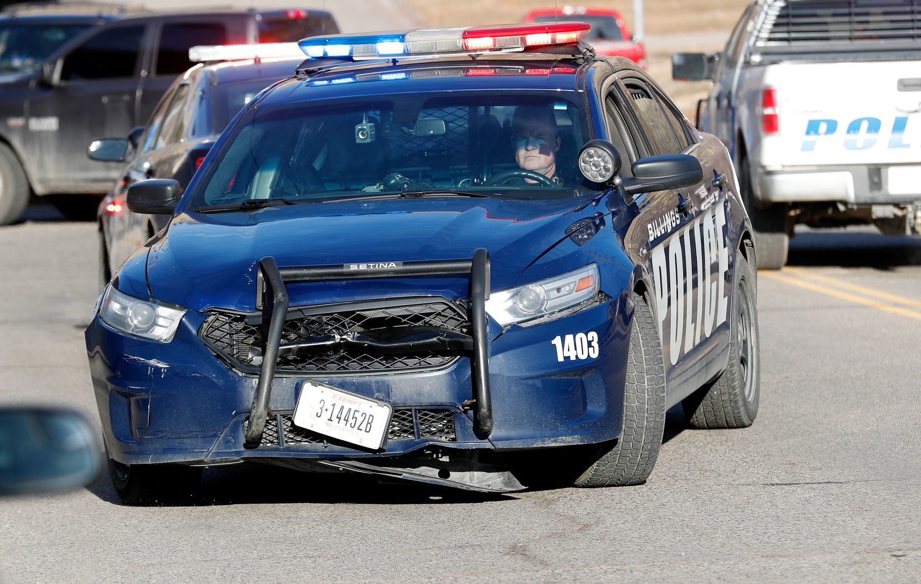 A Billings Police officer moves his car